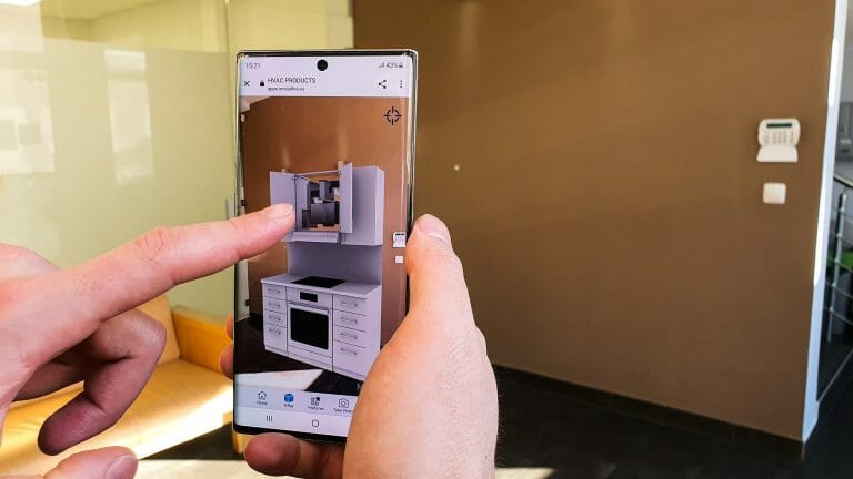 A man holding a phone with HVAC products Virtual Reality app