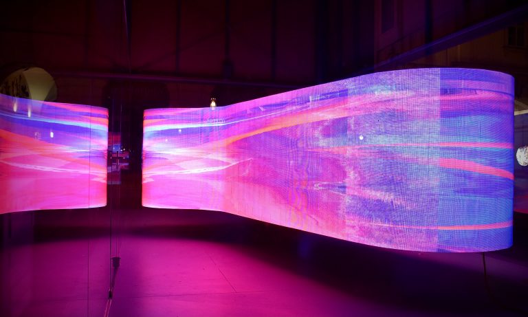 A wall with projection mapping waves